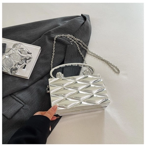 Silver metallic box bag with 3D geometric pattern and lion head hardware detail