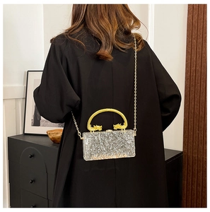 Silver glitter acrylic clutch bag featuring golden twin dragon metal handle and chain strap