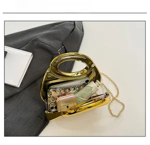 Internal capacity of gold mirror textured handbag with chain and metallic round handle