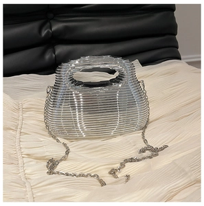 Macro shot of silver textured chain bag featuring a horizontal ripple cage design