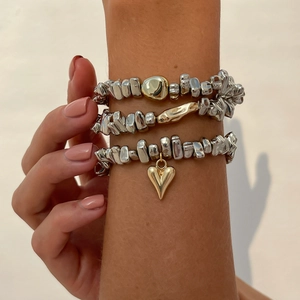 Three-piece silver beaded stretch bracelet set with heart pendant and gold accents