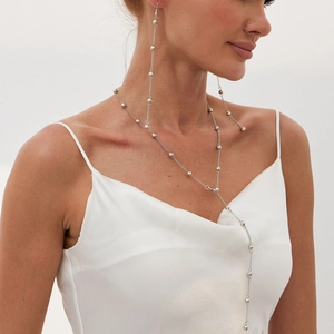 Minimalist silver bead chain necklace set with long tassel earrings on female model