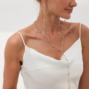 Elegant long silver Y-chain necklace with polished beads on a minimalist metallic strand