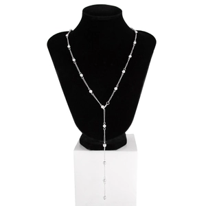 Detail of silver Y-shaped tassel necklace with metal beads on a black velvet mannequin