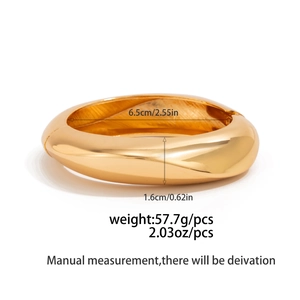 Polished gold wide metal bangle with dimensions 6.5cm diameter and 1.6cm width detail