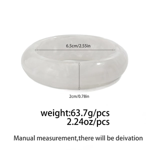 Macro detail of thick resin bangle showing white marble texture and measurement data