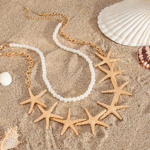 Double-layer ocean style necklace with starfish pendants and white faux pearls on sand