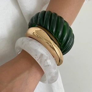 Three-piece chunky resin and gold metal bangle set with marble and spiral patterns