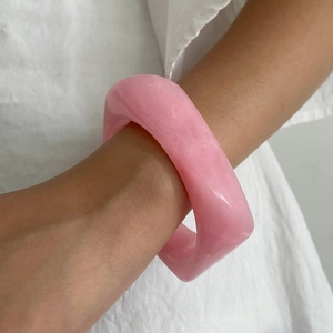 Pink marble texture resin bangle with a chunky geometric design for a modern minimalist look