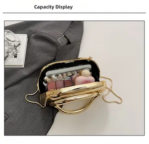Detail view of gold metallic shell bag capacity with phone and cosmetics layout