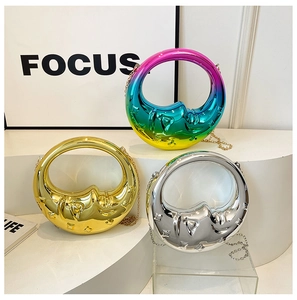 Sleek crescent moon handbags in rainbow, gold, and silver finishes with chain straps