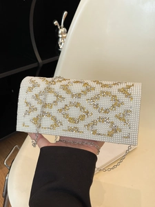 Detail of white pearls and gold sequins geometric pattern on rectangular evening clutch bag