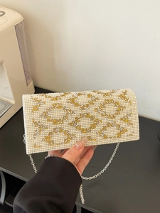Glossy PU leather clutch with pearls and rhinestones featuring a silver chain strap
