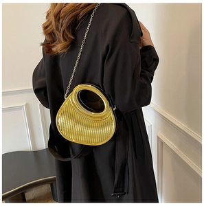 Detailed view of a gold metallic semi-circle clutch bag with vertical pleats and chain