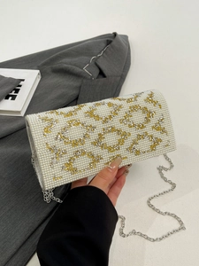 Detail shot of pearl and rhinestone evening clutch with elegant silver chain strap