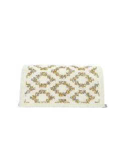 Detail of elegant pearl evening clutch with gold and silver diamond metal studs