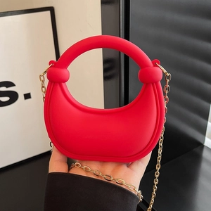 Red mini half-moon crossbody bag with gold chain strap and stylish knot top handle