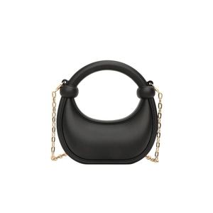Minimalist black crescent handbag with round handle and gold chain strap on white background