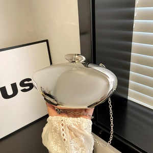 Sleek silver metallic mirror clutch bag with pebble clasp and fine chain strap