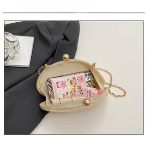 Internal capacity of marble acrylic clutch bag showing phone and lipstick storage