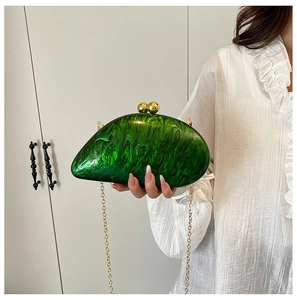 Green marble acrylic evening clutch bag shown with gold chain and spherical clasp