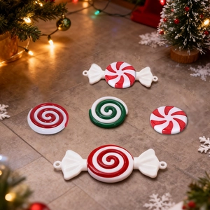 Detailed set of red and green mint candy Christmas ornaments on a grey stone background