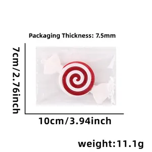 Detailed view of red and white swirl lollipop ornament with dimensions 10cm x 7cm