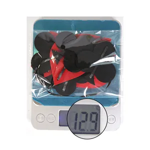 Detailed view of red and black felt poker heart decorations weighing 12.9g on a scale