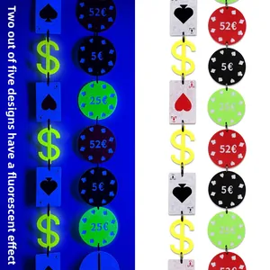 Detail of casino party garland with UV neon poker cards and chip pendants in glow effects