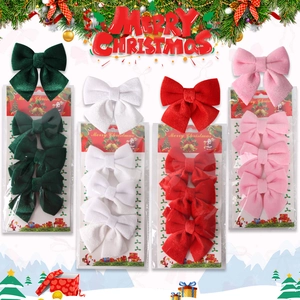 Set of four velvet Christmas bows in green white red and pink for holiday decor