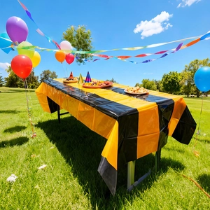 Close-up of waterproof black and gold striped plastic tablecloth for outdoor birthday party