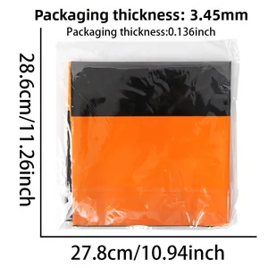 Detail view of orange and black party tablecloth in packaging with size measurements