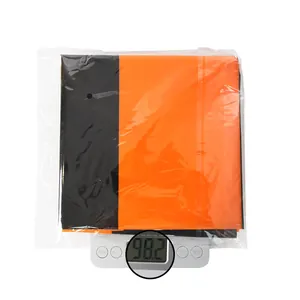 Macro view of folded orange and black Halloween tablecloth on a scale weighing 98.2g