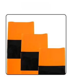Close-up of orange and black disposable table covers showing glossy material and texture