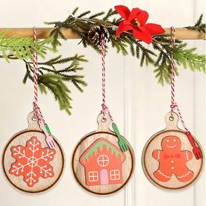 Close-up of wooden Christmas ornaments featuring snowflake, cottage, and gingerbread man
