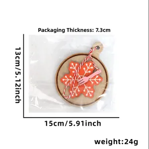 Detail of wooden Christmas ornament with red snowflake pattern and pink fork decoration