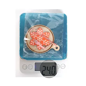 Wooden snowflake hanging ornament weighing 24.0g on a digital scale for DIY decoration
