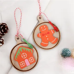 Detail of wooden gingerbread man and house ornaments with red and white cotton ropes