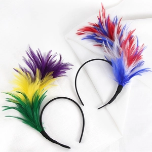 Detail of colorful carnival feather headbands with vibrant green, gold, and purple plumes