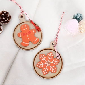 Detail of wooden Christmas ornaments featuring a gingerbread man and snowflake design