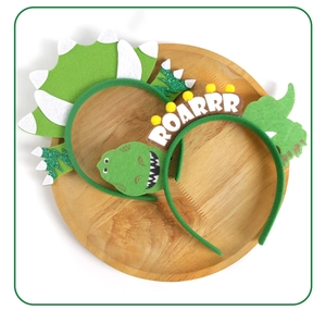 Detail of green felt dinosaur headband with ROARRR embroidery and soft spikes for kids