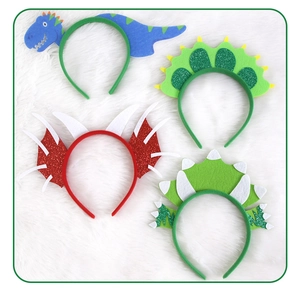 Detailed view of four felt dinosaur headbands with glitter accents for kids parties