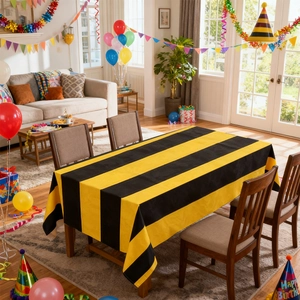 Rectangular party tablecloth featuring bold black and yellow stripes for festive celebrations