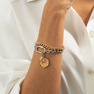 Detail of two-tone double layer bracelet with gold star charms and large silver clasp