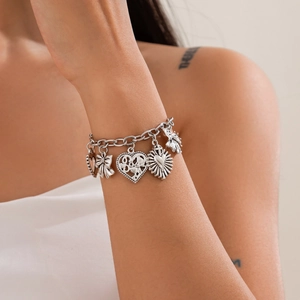 Vintage silver chain bracelet featuring celestial sun moon charms and engraved heart pendants