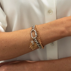 Hip hop layered chain bracelet with gold starburst pendant and silver carabiner lock