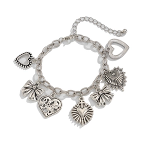 Vintage silver chain bracelet with moon sun and heart charms on white background