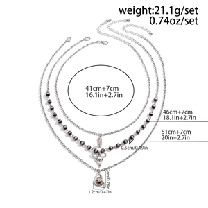 Detailed view of silver western style necklace set with boots and skull charm dimensions