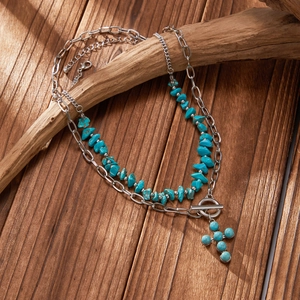 Detail of vintage turquoise beaded cross necklace with silver paperclip chain and OT clasp