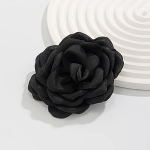 Detail of handcrafted black fabric rose anklet accessory with multi-layer floral petals